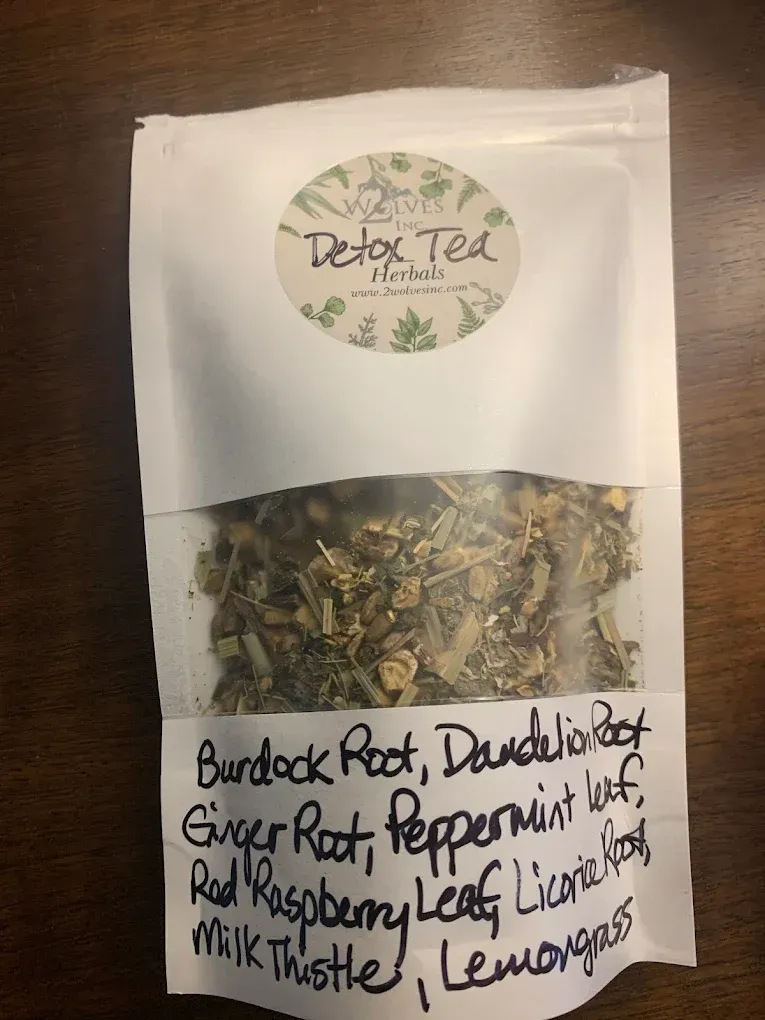 Herbal tea pouch labeled with loose-leaf tea and handwritten ingredient list visible at the bottom