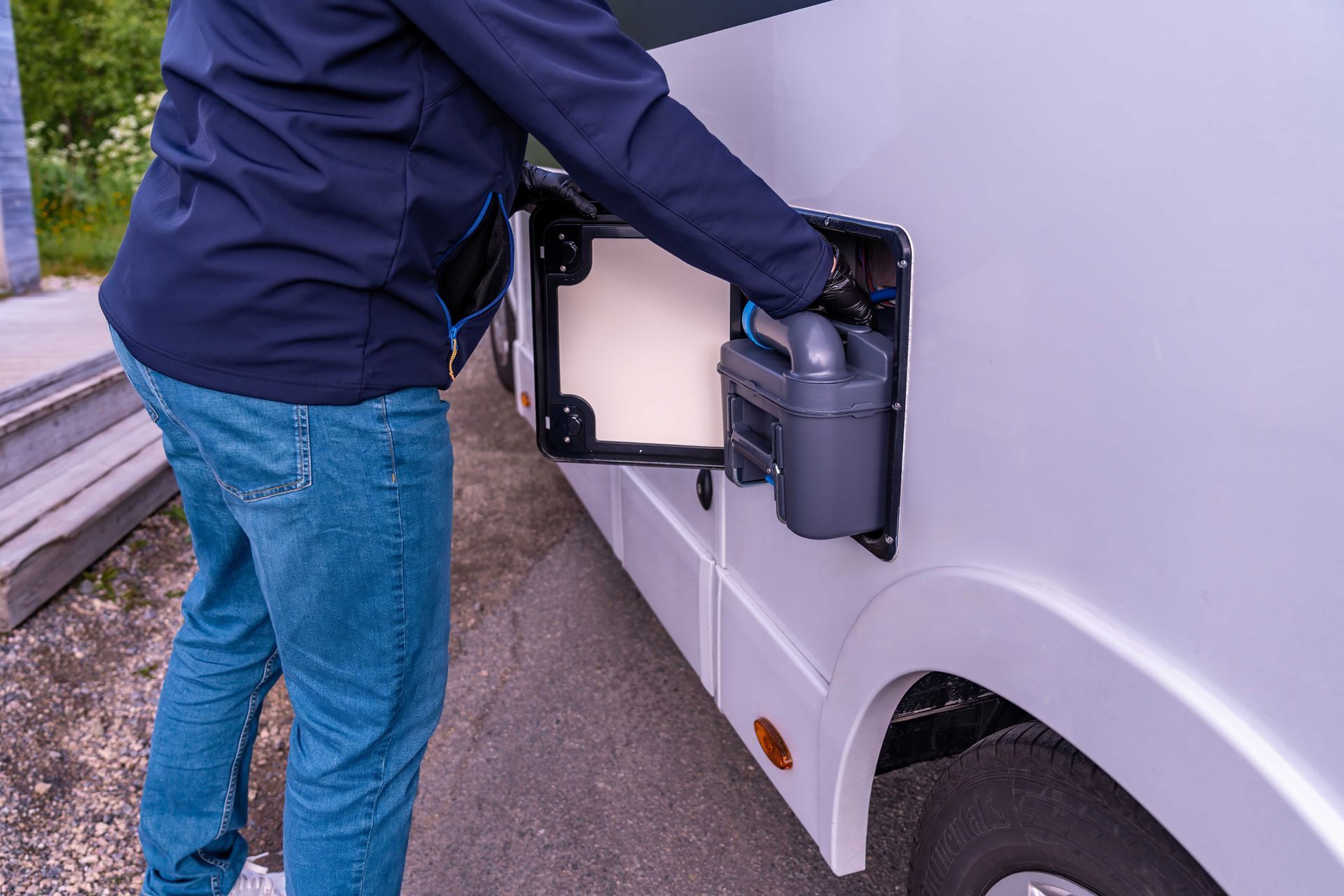 Motorhome repair services technician working on an RV coach. Motorhome repair services technician working on an RV coach.
