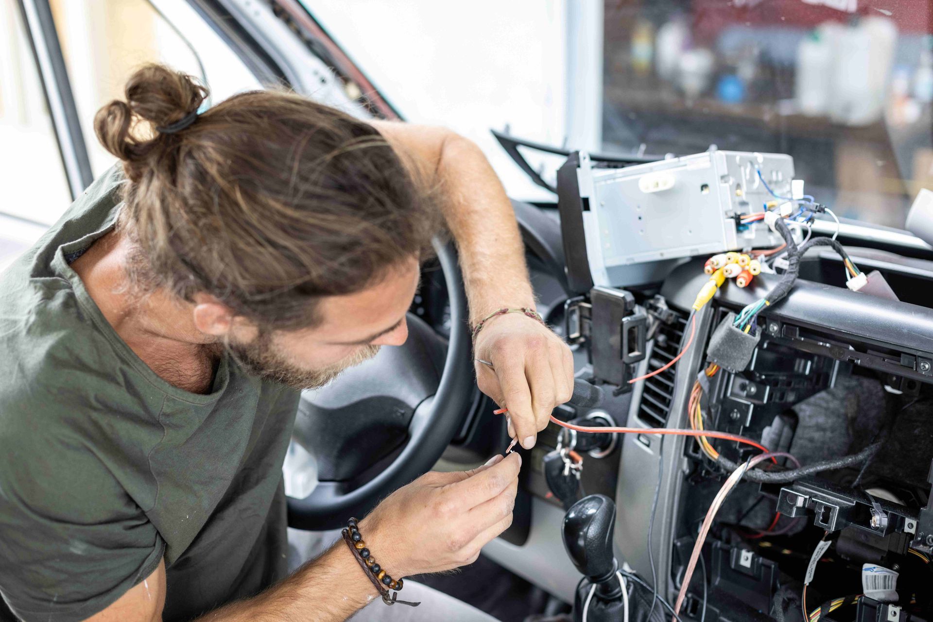 Technician performing RV electrical repair shop wiring diagnostics on a dashboard. Technician performing RV electrical repair shop wiring diagnostics on a dashboard.
