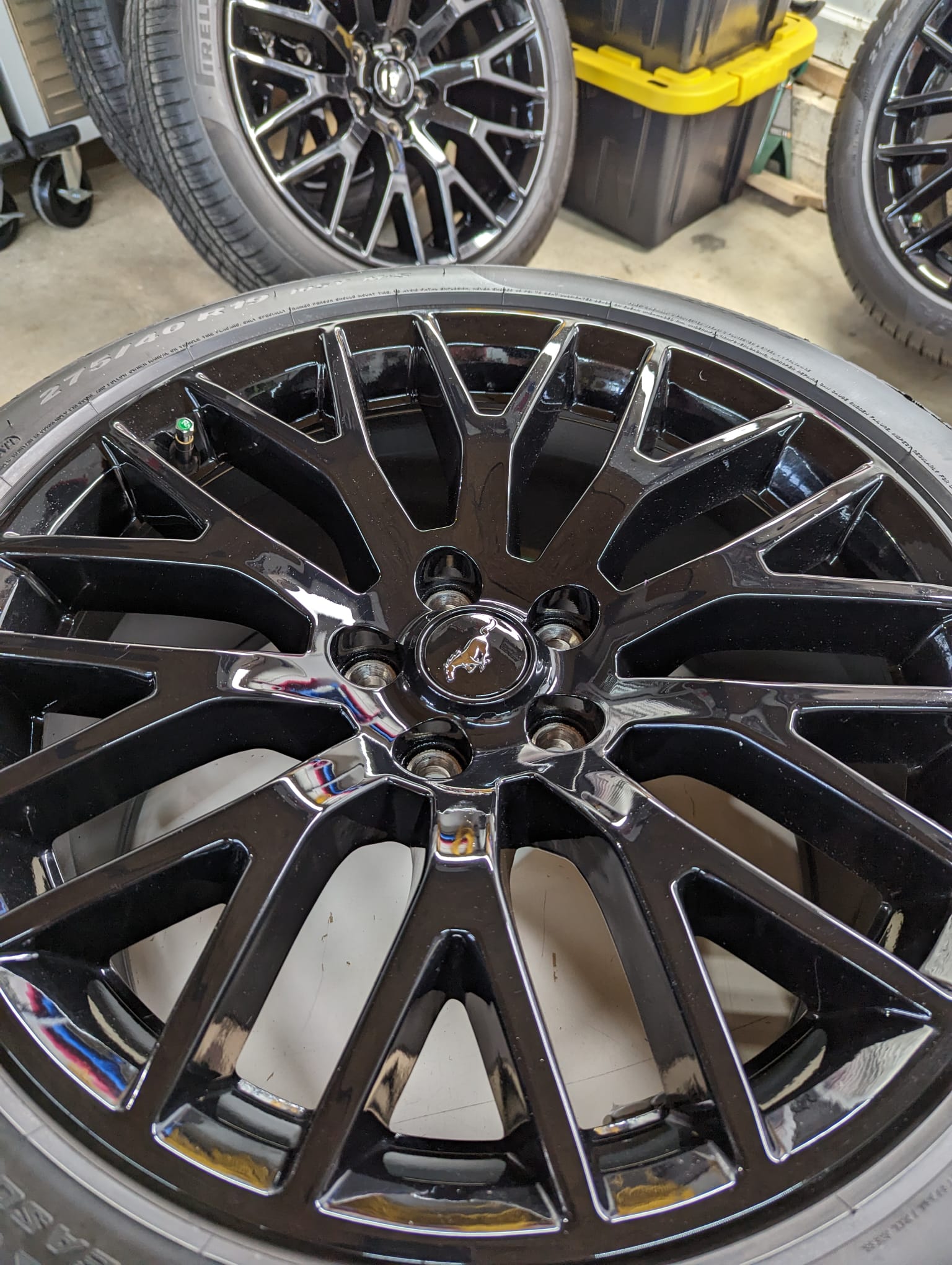 A close up of a black wheel with a tire on it.