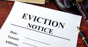 Eviction notice and gavel on a table.