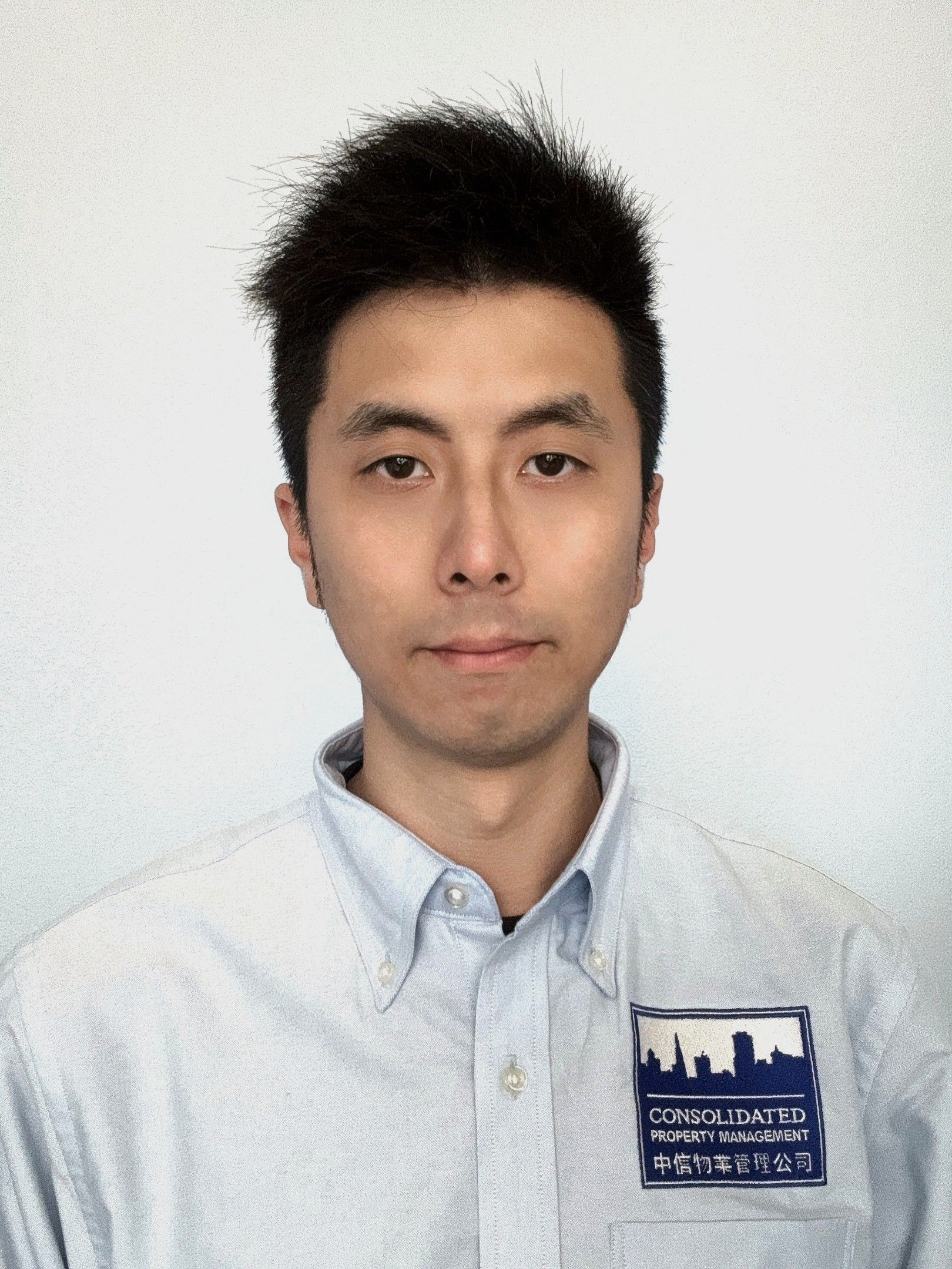 A man wearing a blue shirt with a city on it