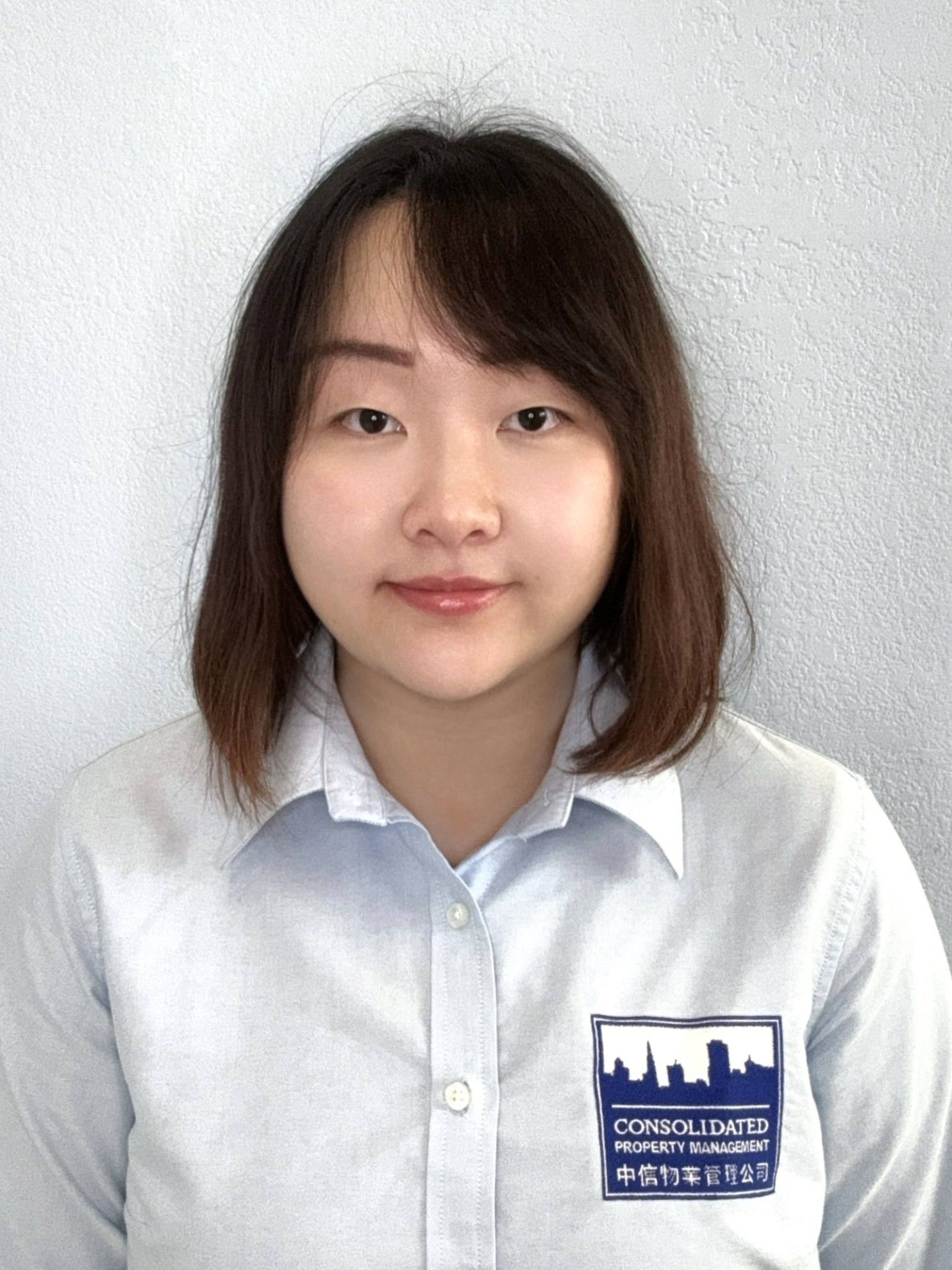 The woman is wearing a white shirt and smiling for the camera.