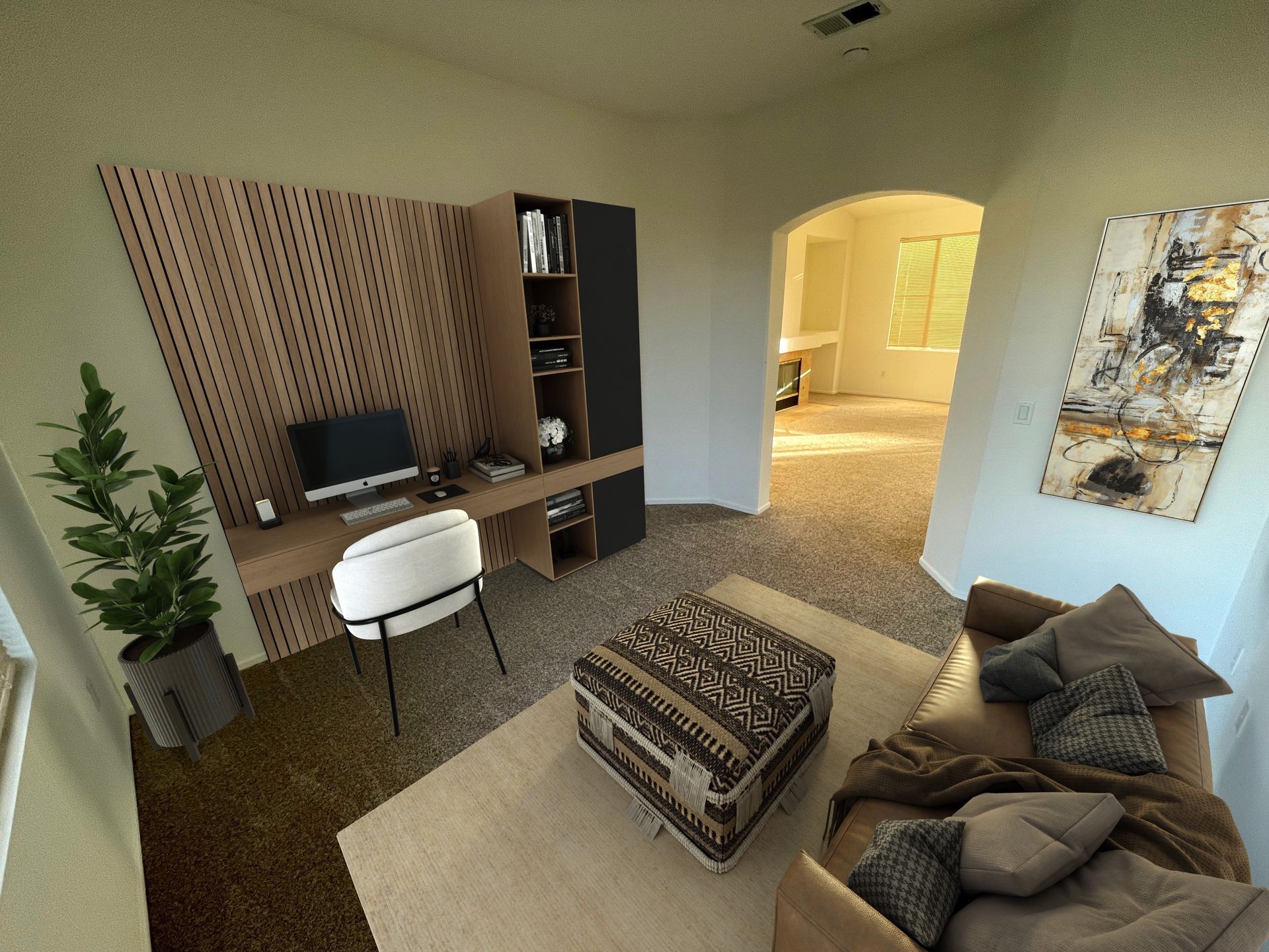 A living room with a couch and a desk with a computer on it