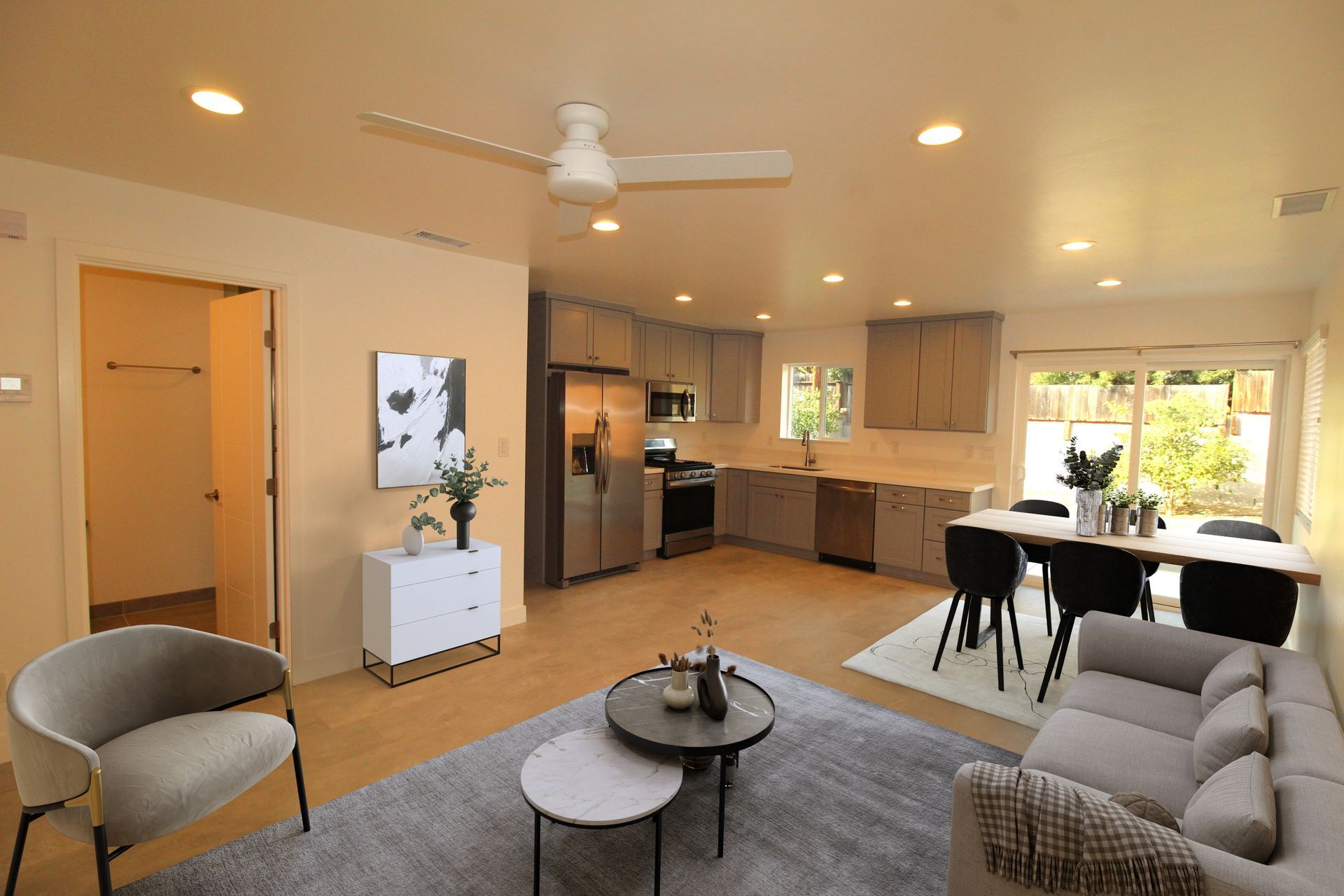 A living room filled with furniture and a ceiling fan.