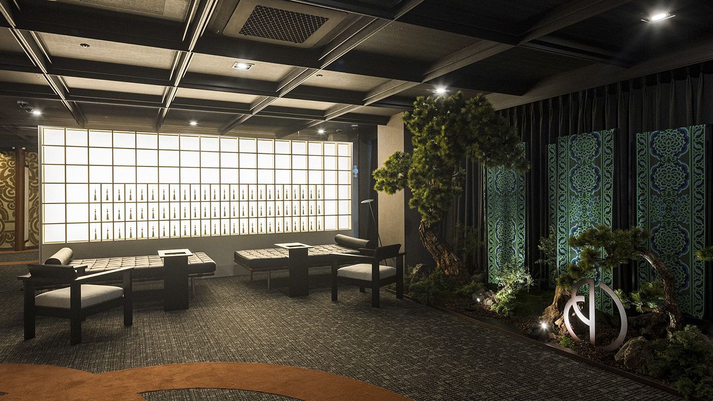Lounge with a glowing glass-block wall and bonsai