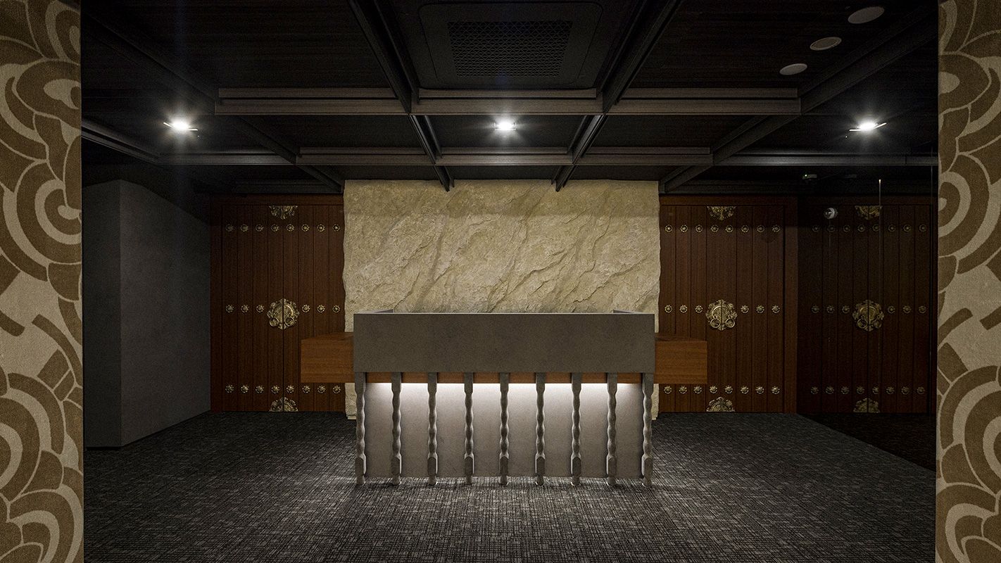 Reception desk in stone and dark wood