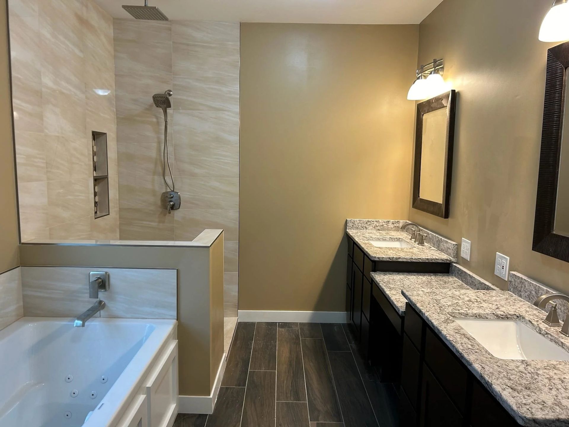 Modern bathroom with soaking tub, walk-in shower, and double vanity with granite counters
