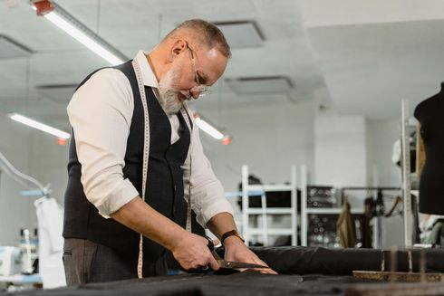 Small business owner reviewing marketing analytics dashboard on laptop to track ad spend and ROI