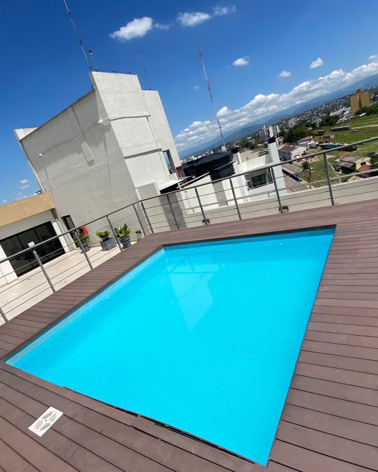 A large swimming pool on the roof of a building