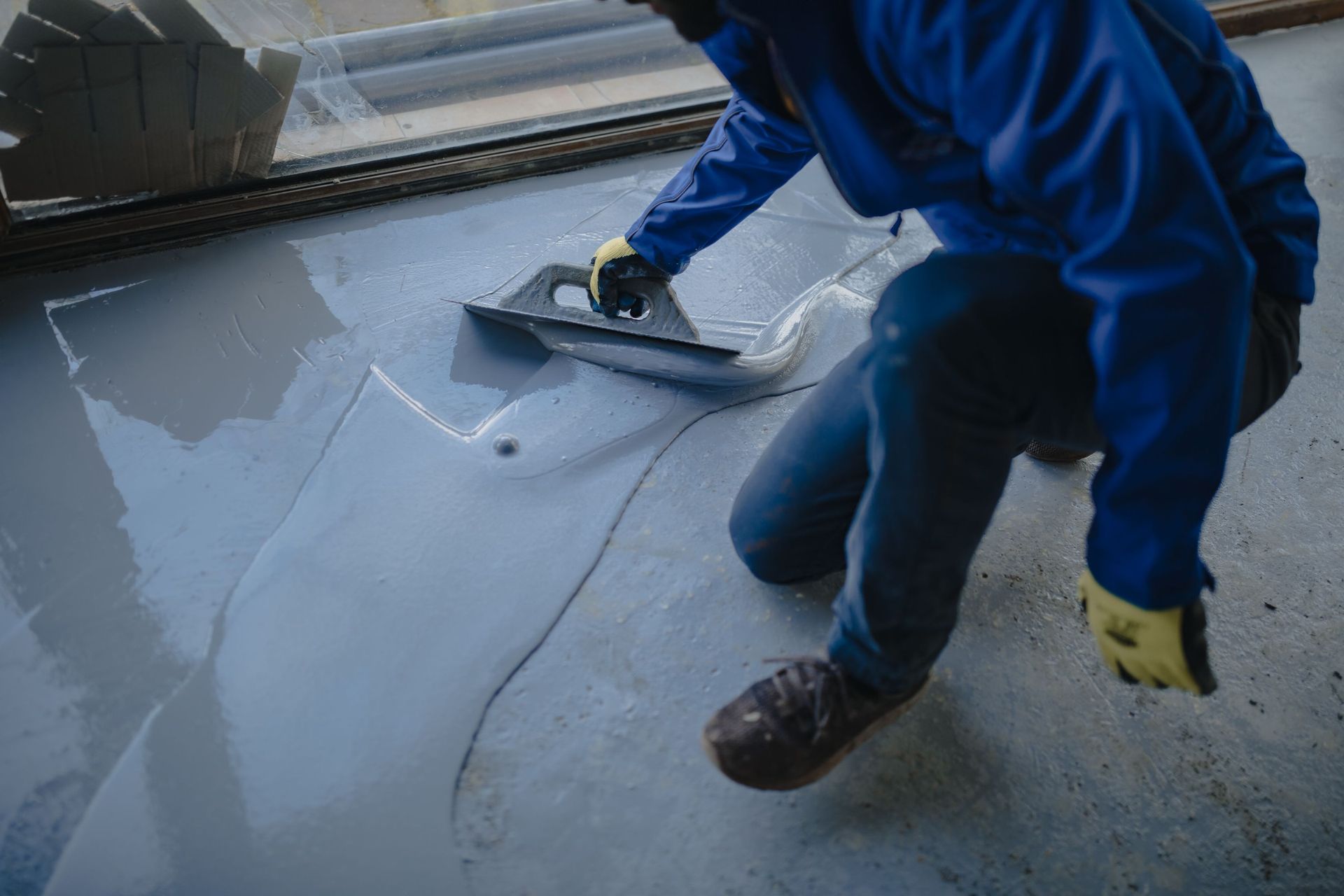 worker applies gray epoxy resin new
