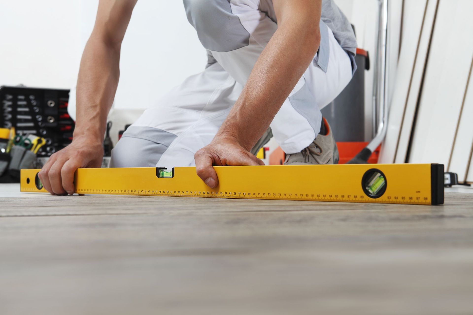 man worker hands installing timber laminate