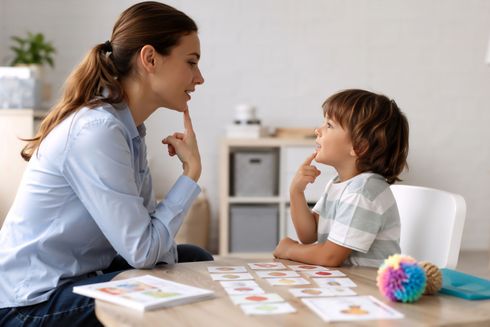 Communication disorder support working with a young child on speech