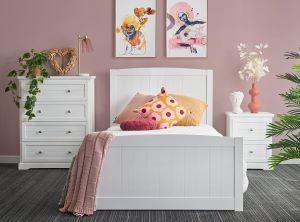 kids bedroom with a white bed, bedside table and a tallboy