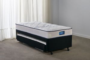 a single bed with a built-in trundle mattress underneath 