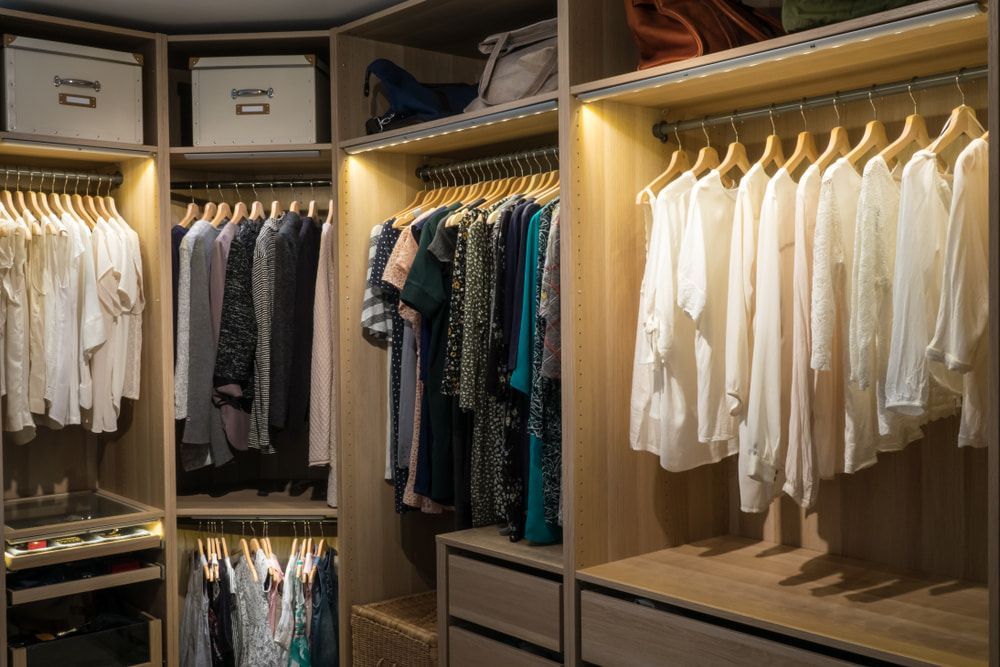A Walk in Closet Filled with Lots of Clothes and Boxes — Peter Whelan Building Services in Avoca, NSW