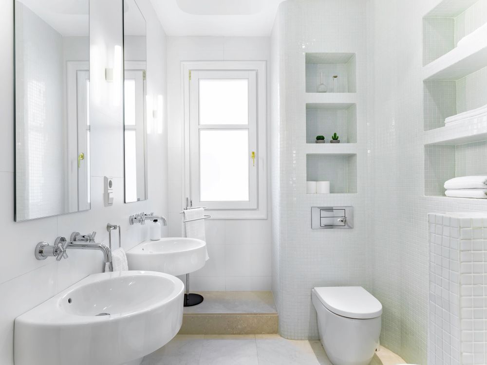 A Bathroom with Two Sinks, a Toilet and A Window — Peter Whelan Building Services in Morisset, NSW