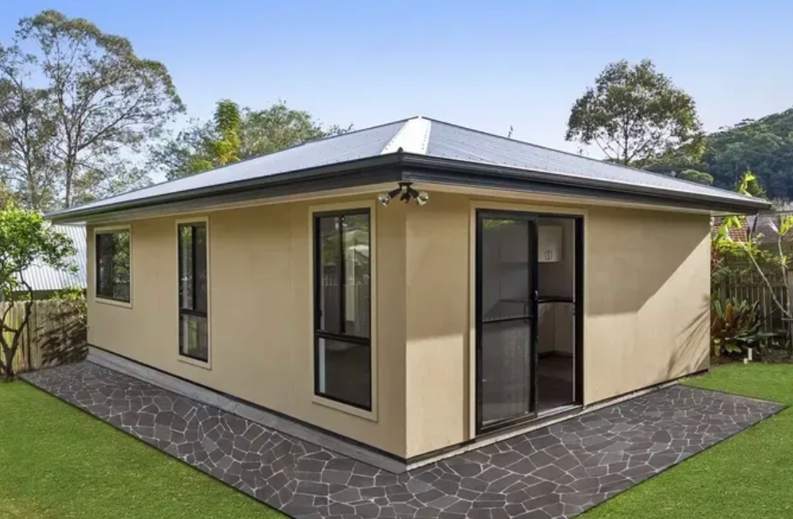 The Back of a Home Enclosed by a Green Backyard — Peter Whelan Building Services in Wyoming, NSW