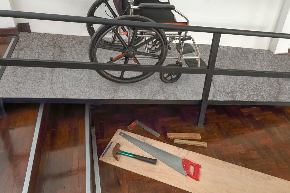 Wheelchair on Ramp Above a Saw, Tools, and Wood — Peter Whelan Building Services in Wyoming, NSW