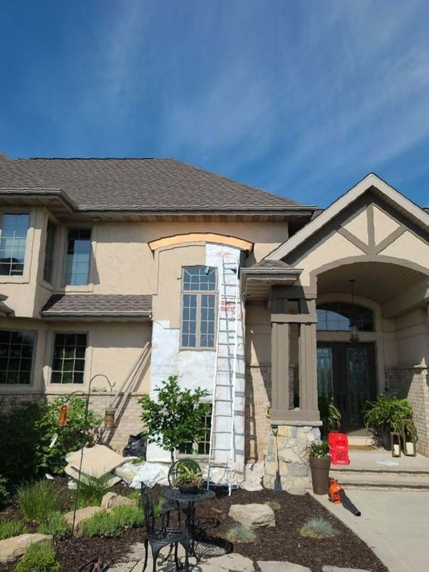 A large house with a ladder in front of it