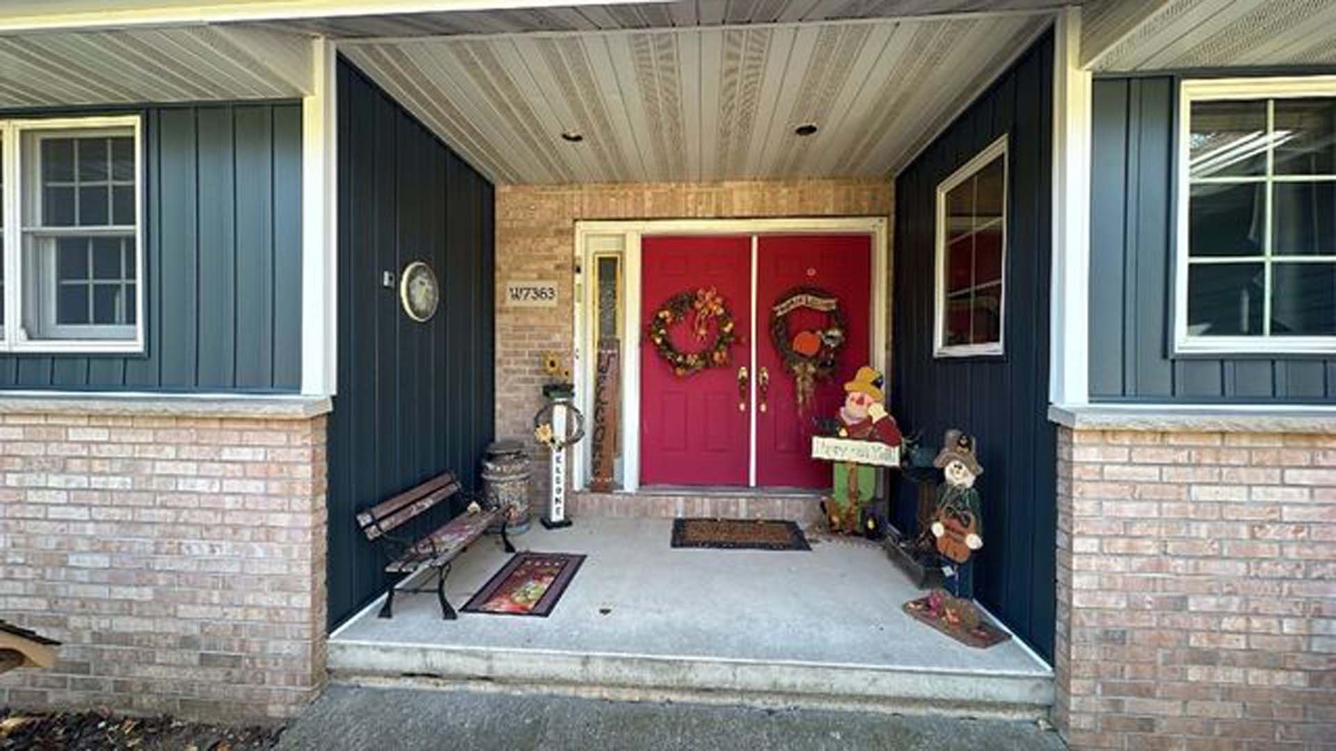 The front door of a house has a wreath on it