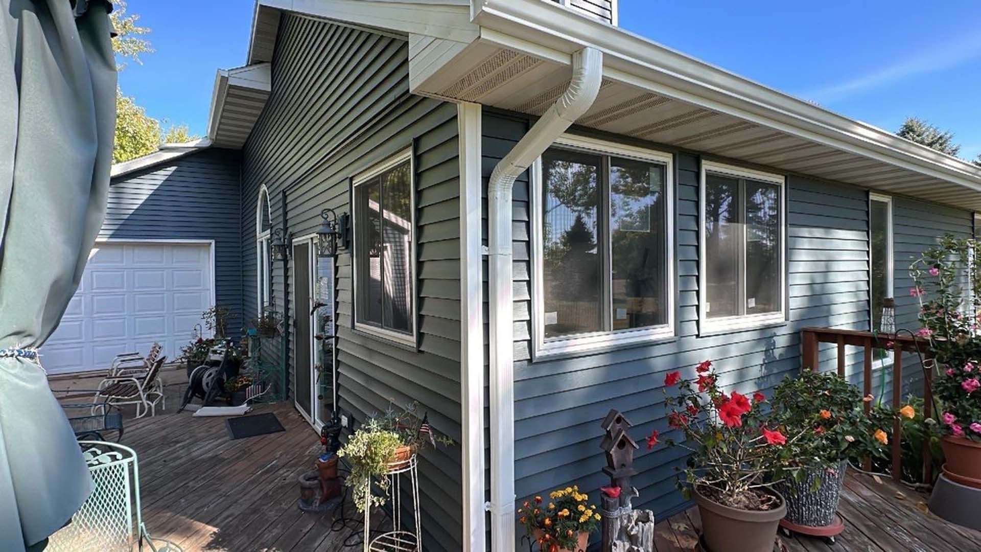 A house with a lot of windows and flowers in front of it.