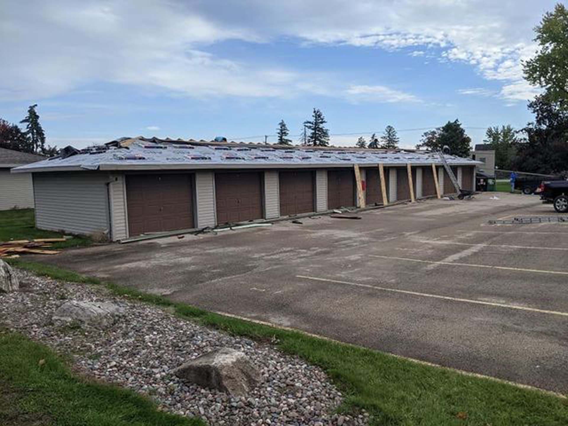 A row of garage doors are being installed on a building.