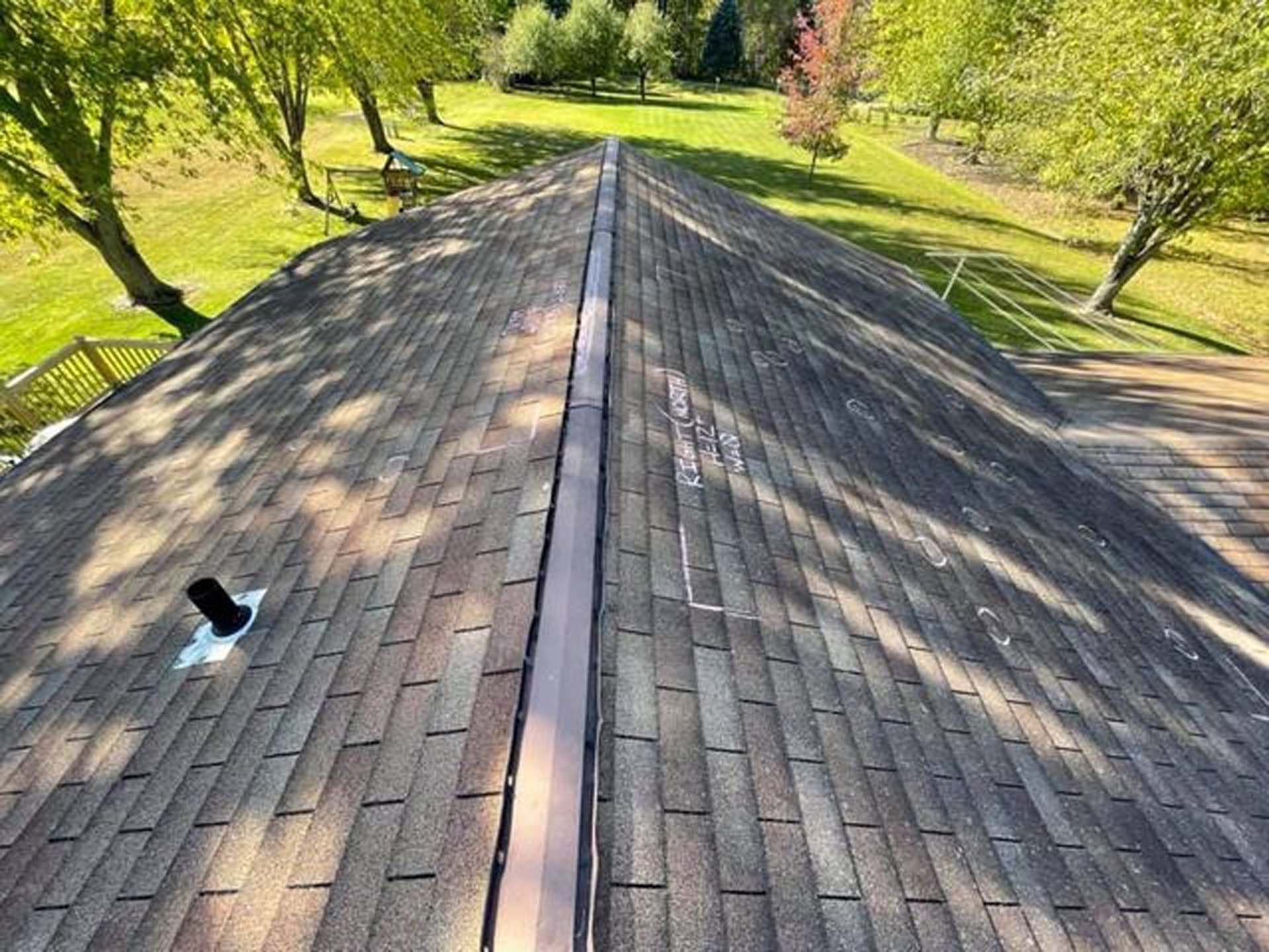 An aerial view of a roof with trees in the background.