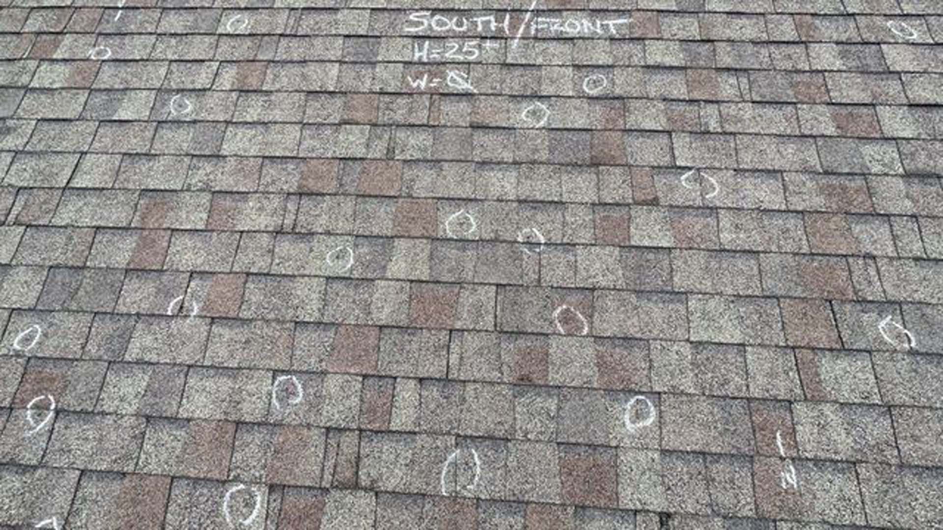 A close up of a roof with hail damage on it.