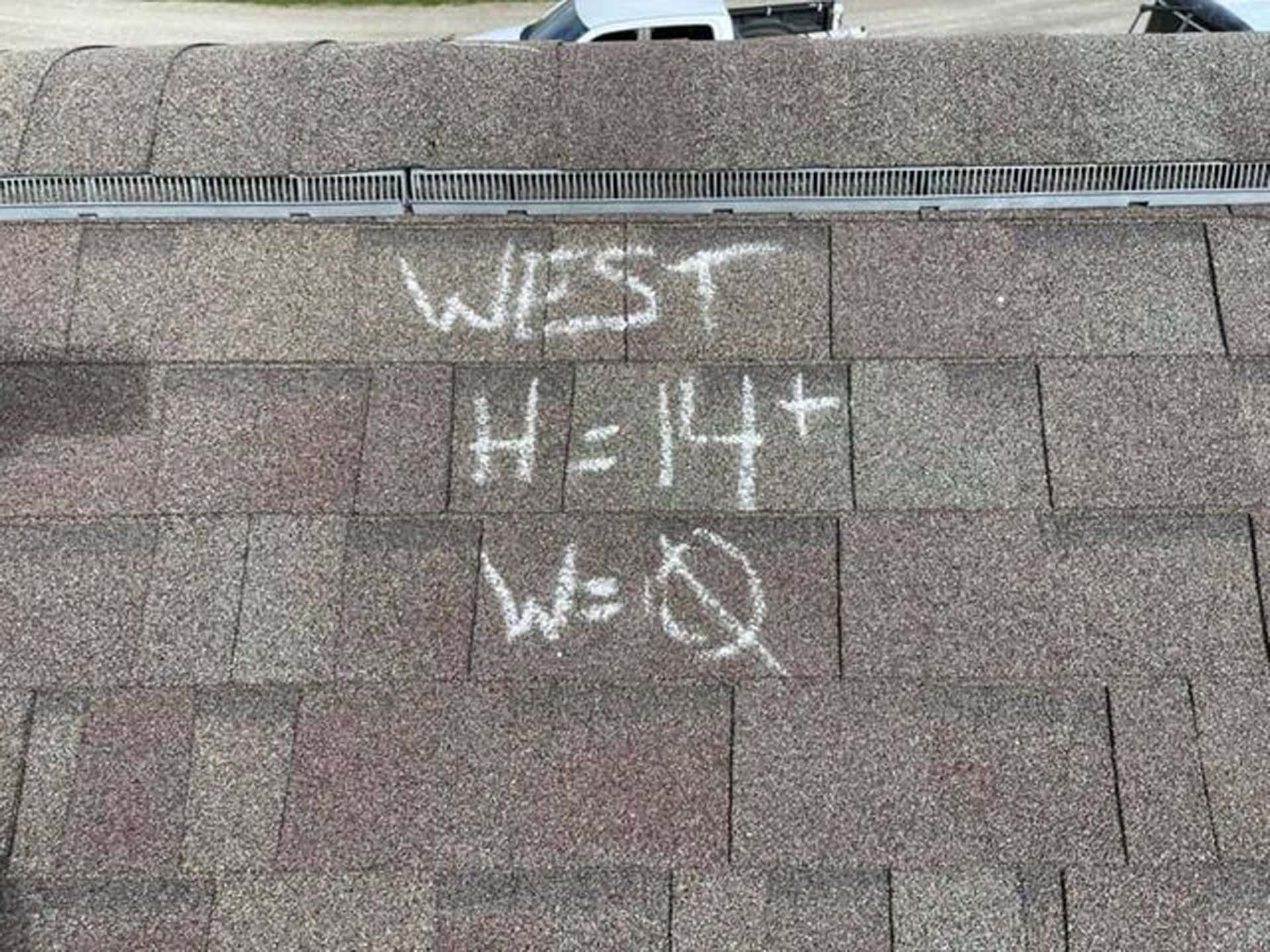 A close up of a roof with chalk written on it.