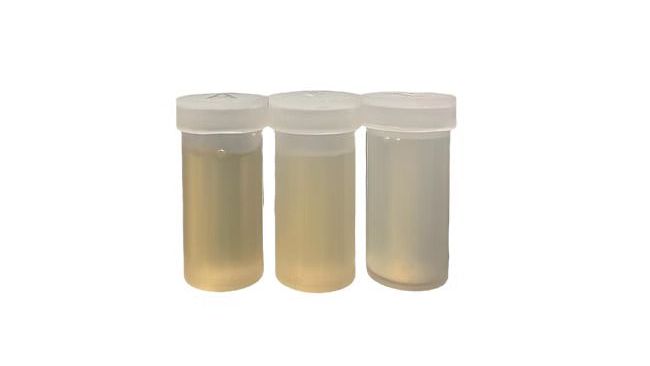 Three test tubes filled with different colored liquids on a white background.