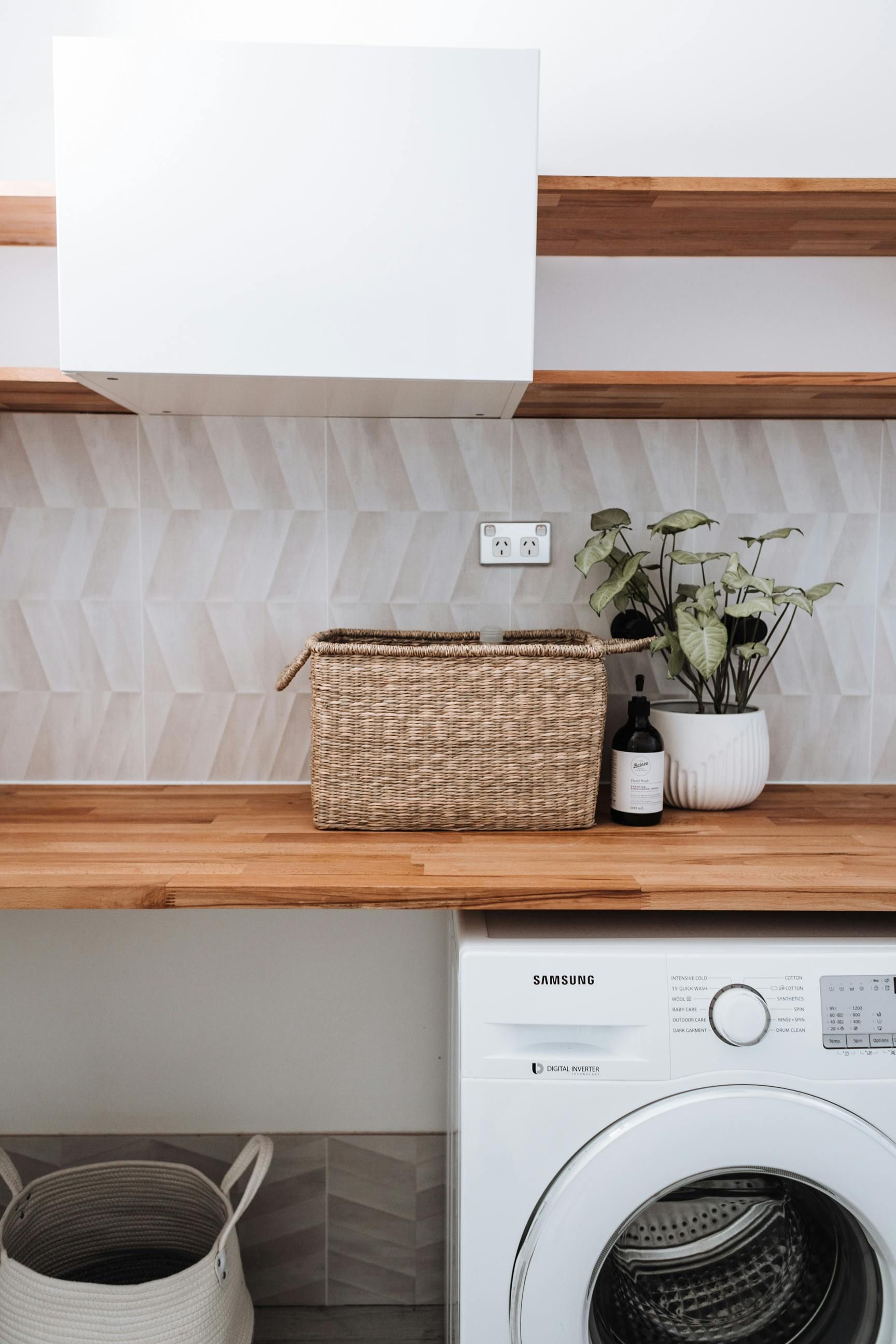 A Person Is Laying Tiles On The Floor With A Trowel — Smart Tiles In South Kempsey, NSW