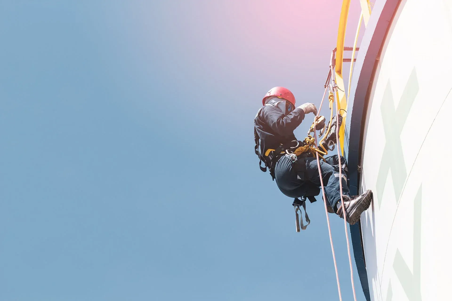 A man is climbing up the side of a building.