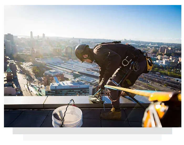 A man is working on the roof of a building.