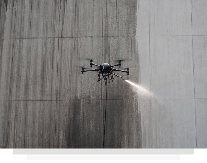 a drone cleaning a high building wall