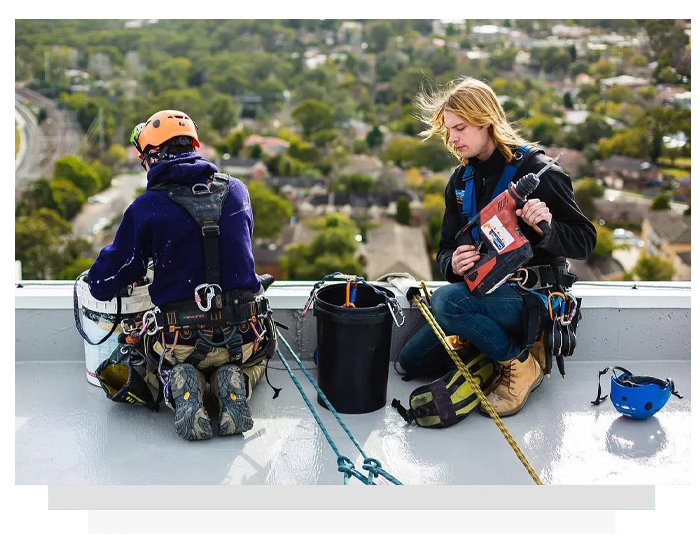 two man setting up protective coatings for a high rise