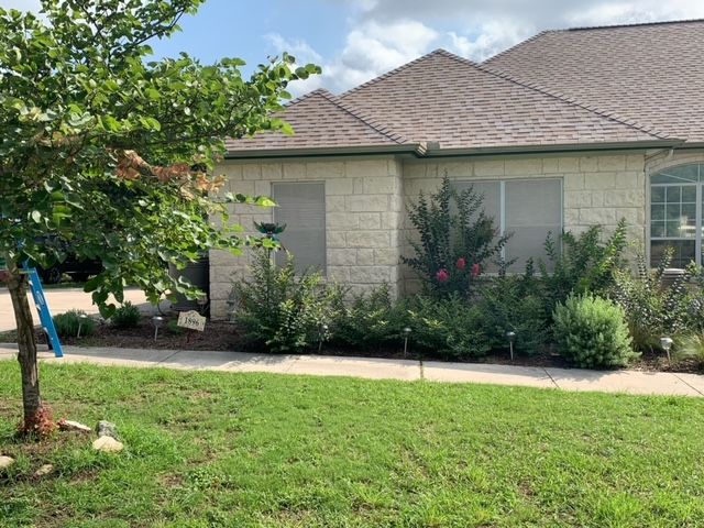 A house with a large lawn in front of it