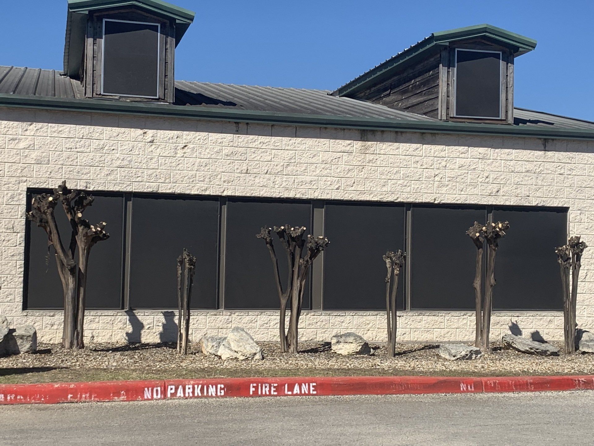 A brick building with a fire lane in front of it