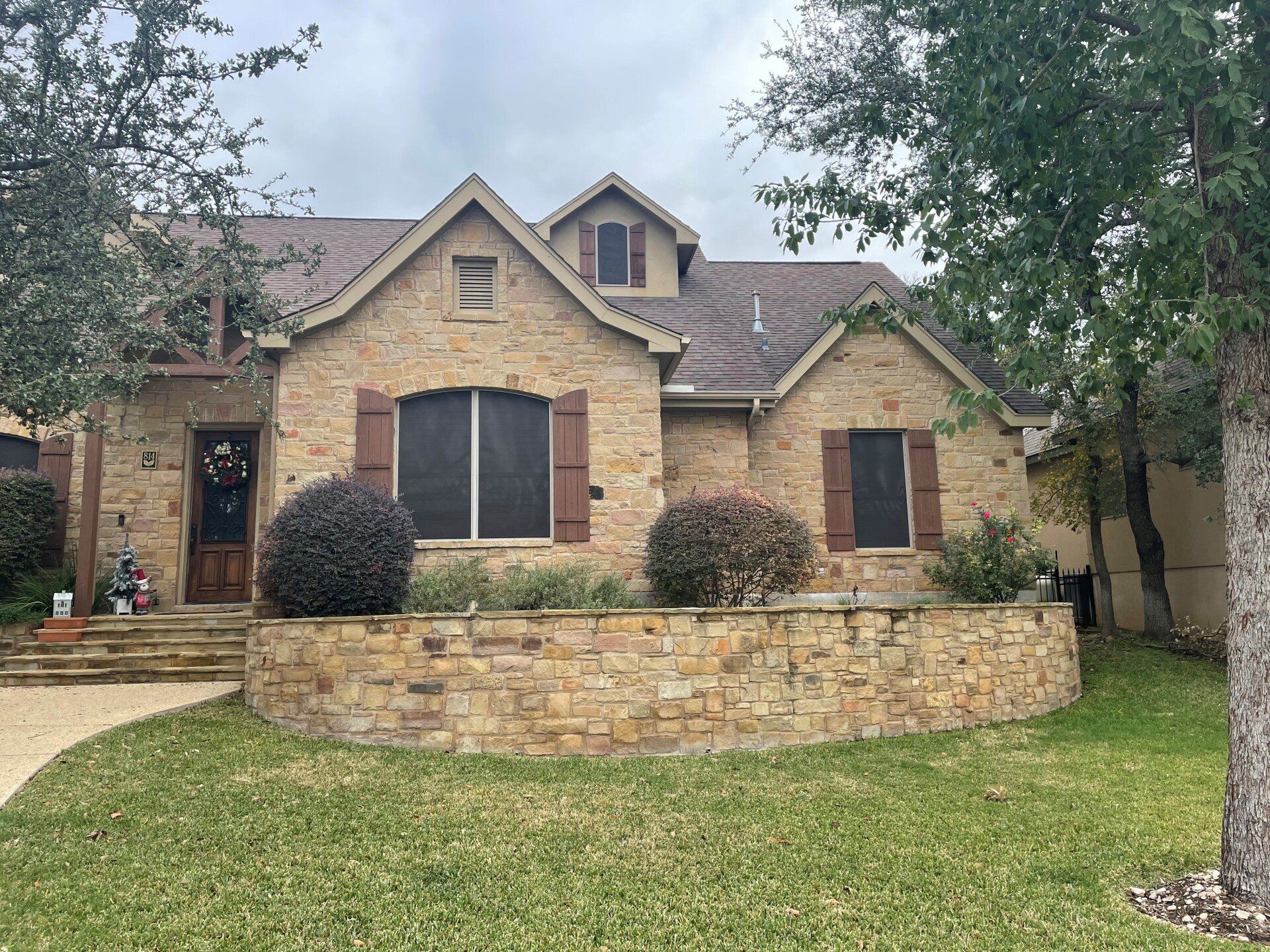 A large brick house with a large lawn in front of it