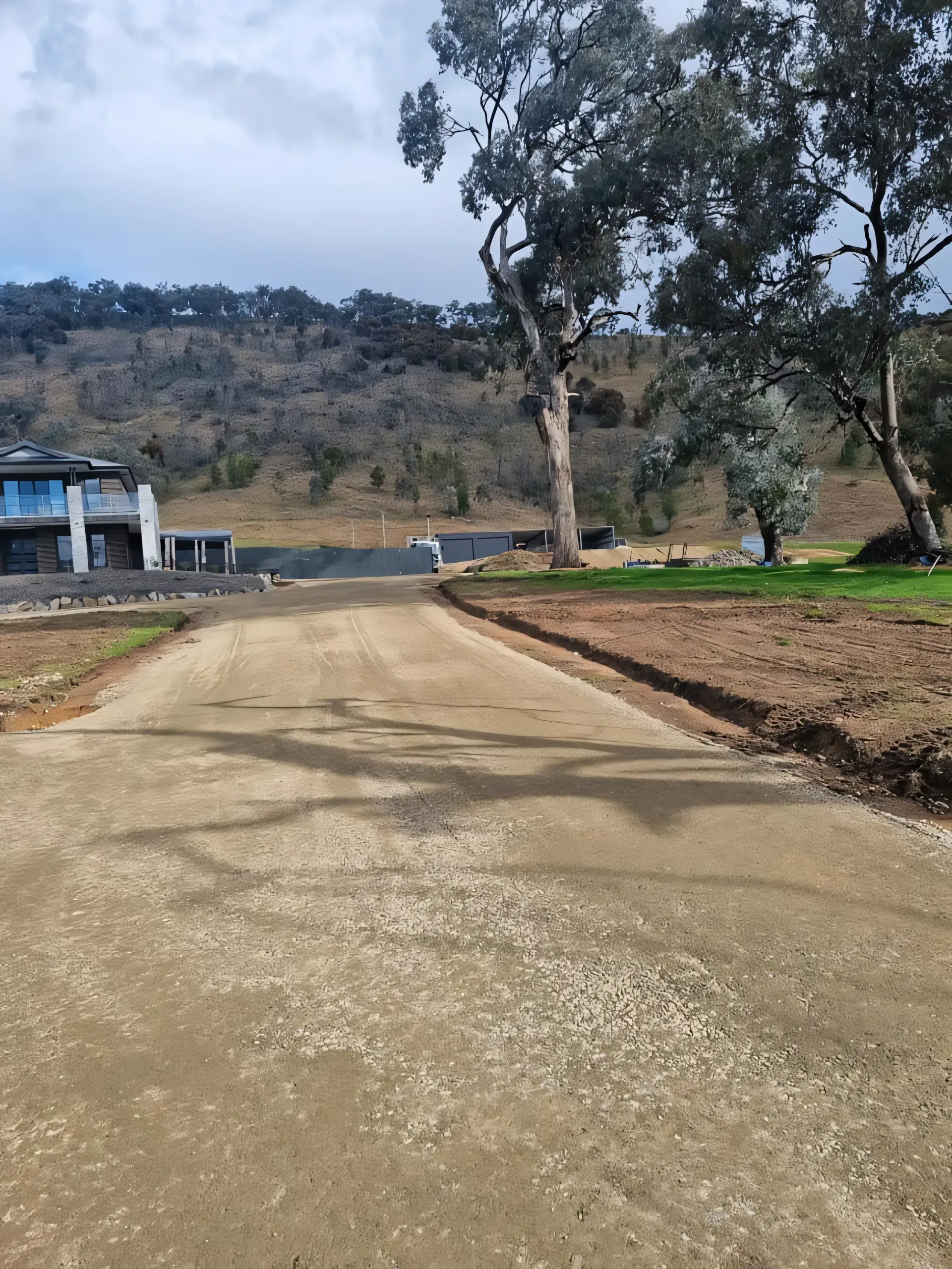 A Dump Truck Is Towing A Large Excavator On A Flatbed Trailer — Grants Excavations In Osbornes Flat, VIC
