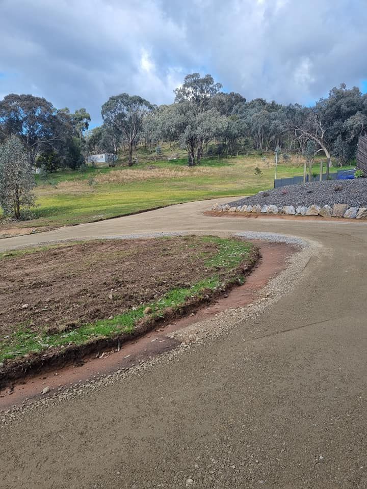 A dirt road going through a field with trees in the background. — Grants Excavations In Osbornes Flat, VIC
