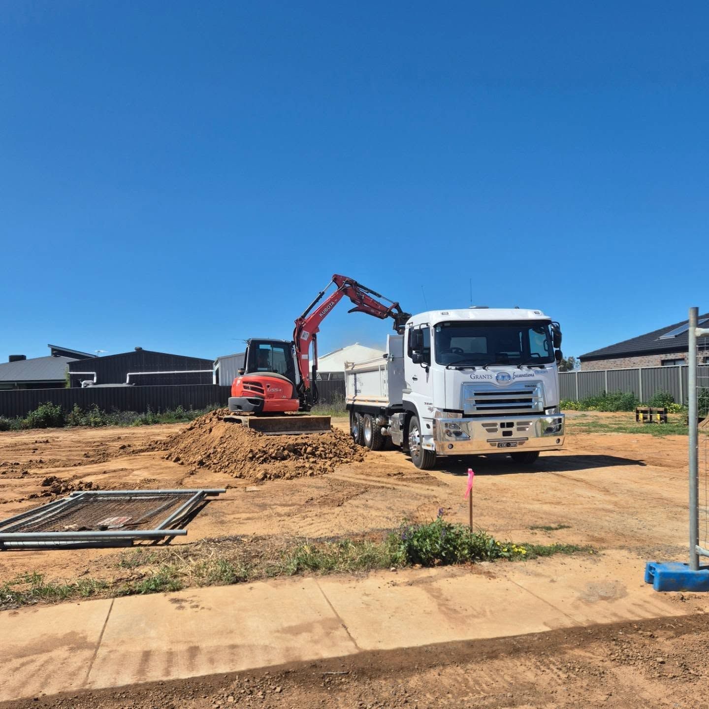 A Dump Truck Is Parked In A Dirt Lot Next To An Excavator — Grants Excavations In Osbornes Flat, VIC