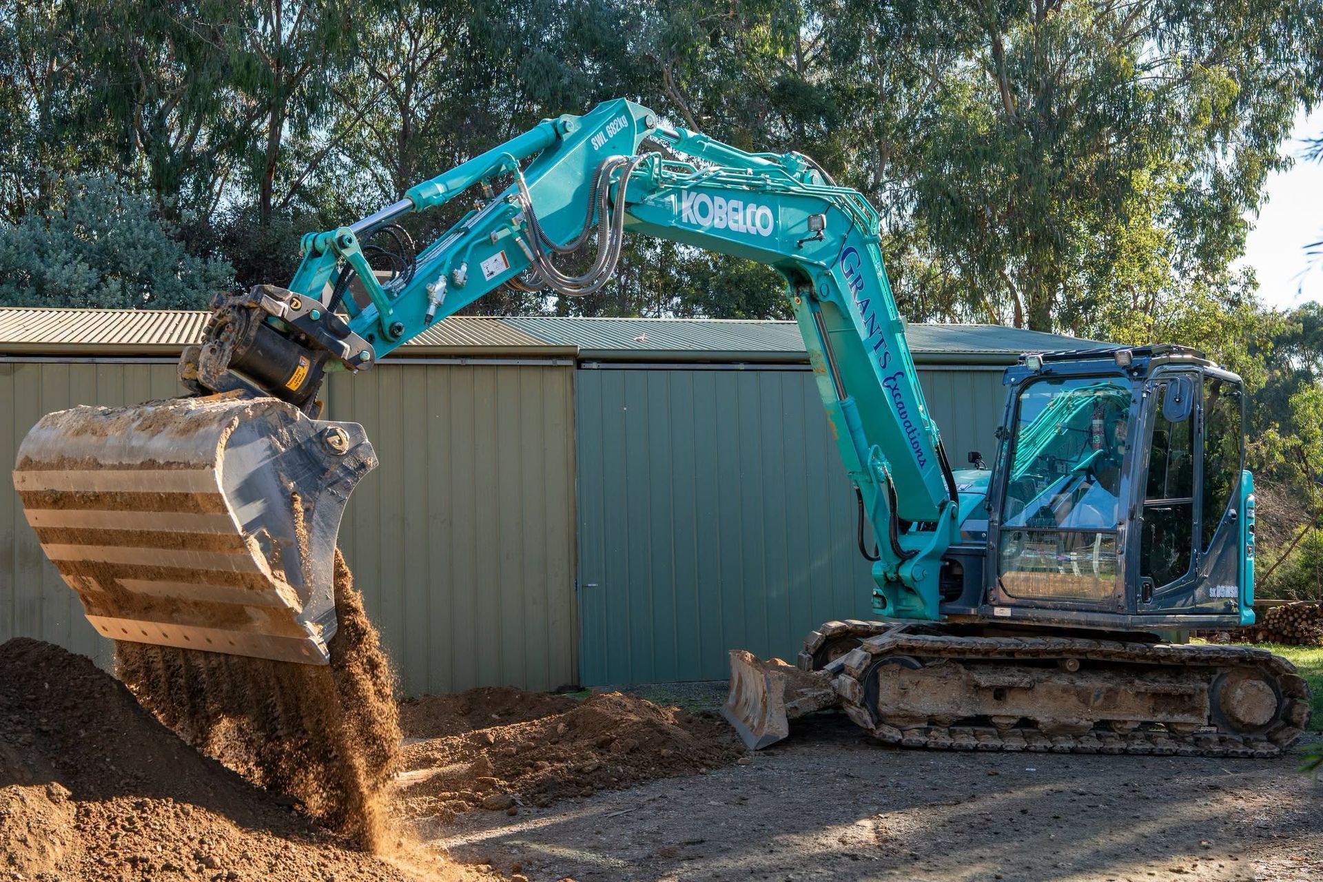A Dirt Road Going Through A Forest With Trees In The Background — Grants Excavations In Osbornes Flat, VIC