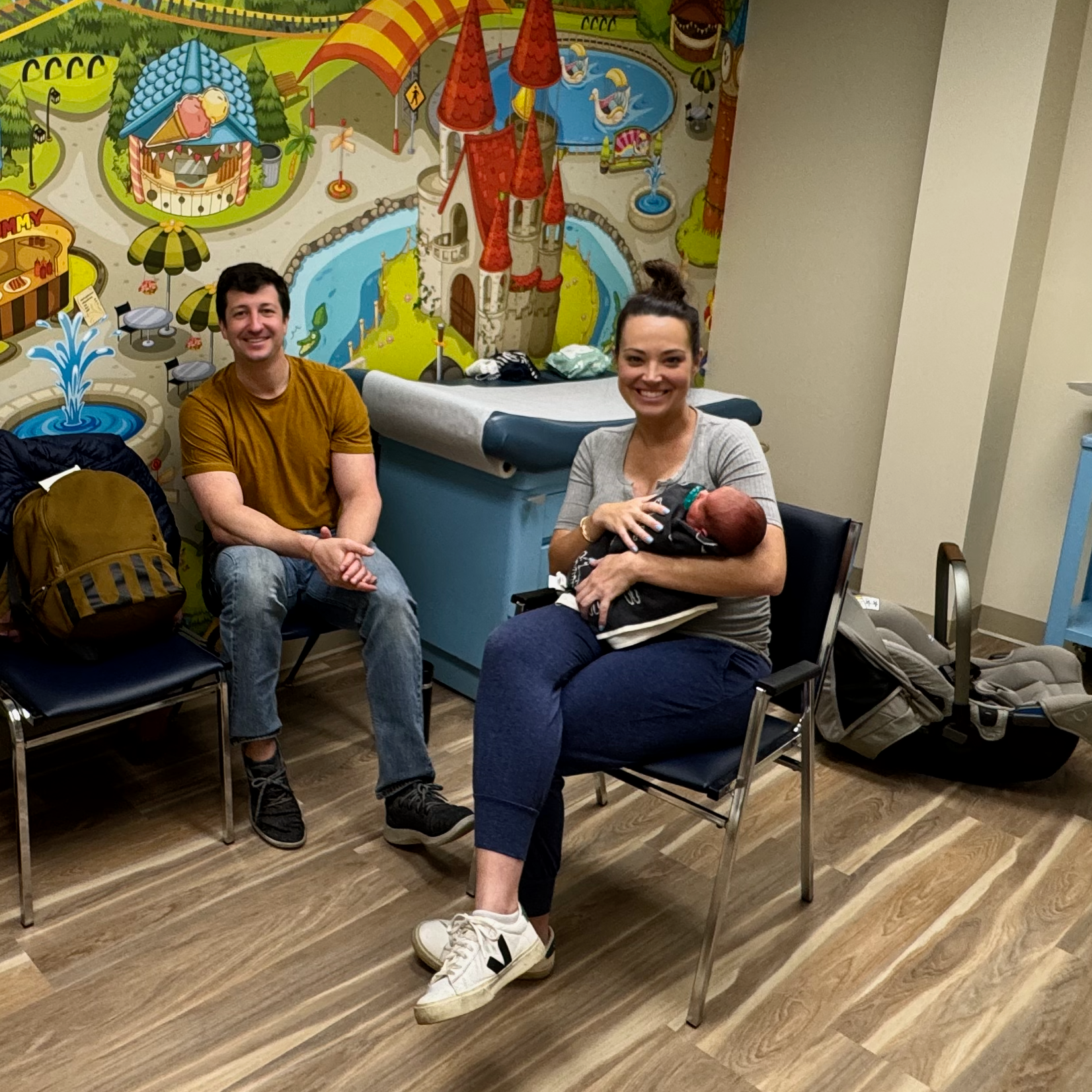 Parents of a newborn baby waiting to be seen at a pediatrician's office