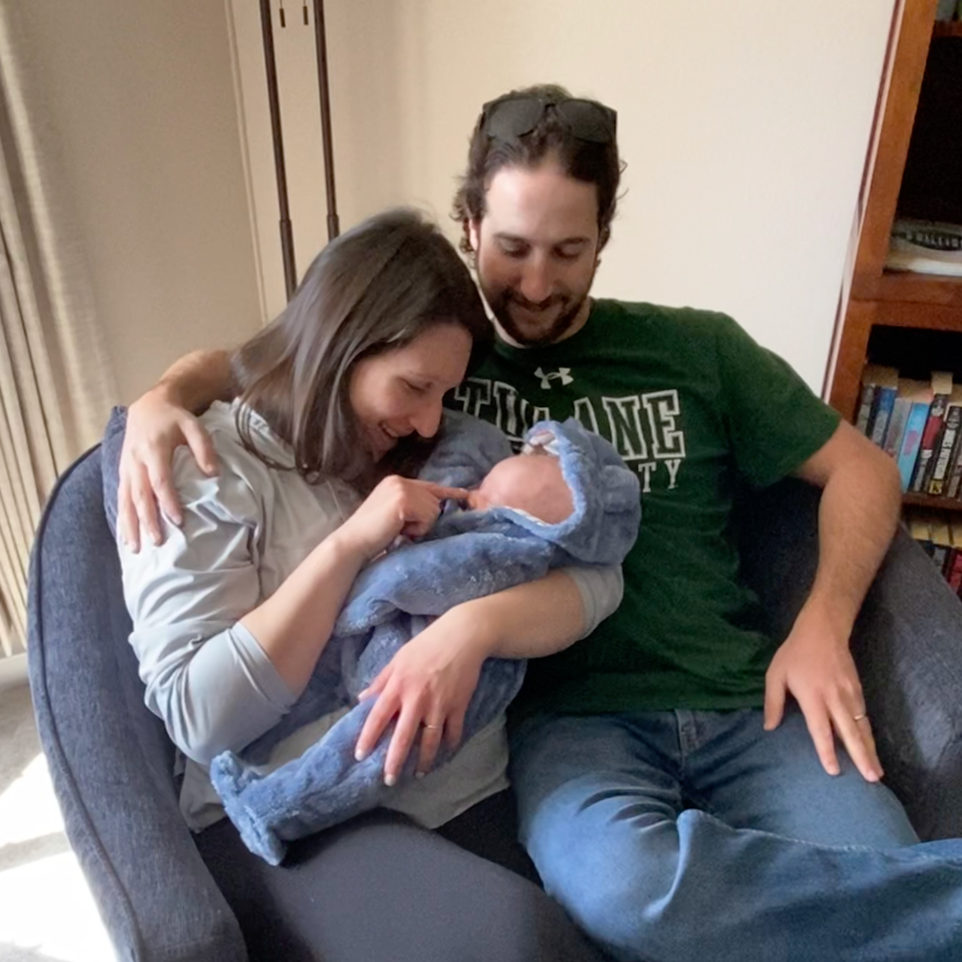 New parents holding their newborn baby