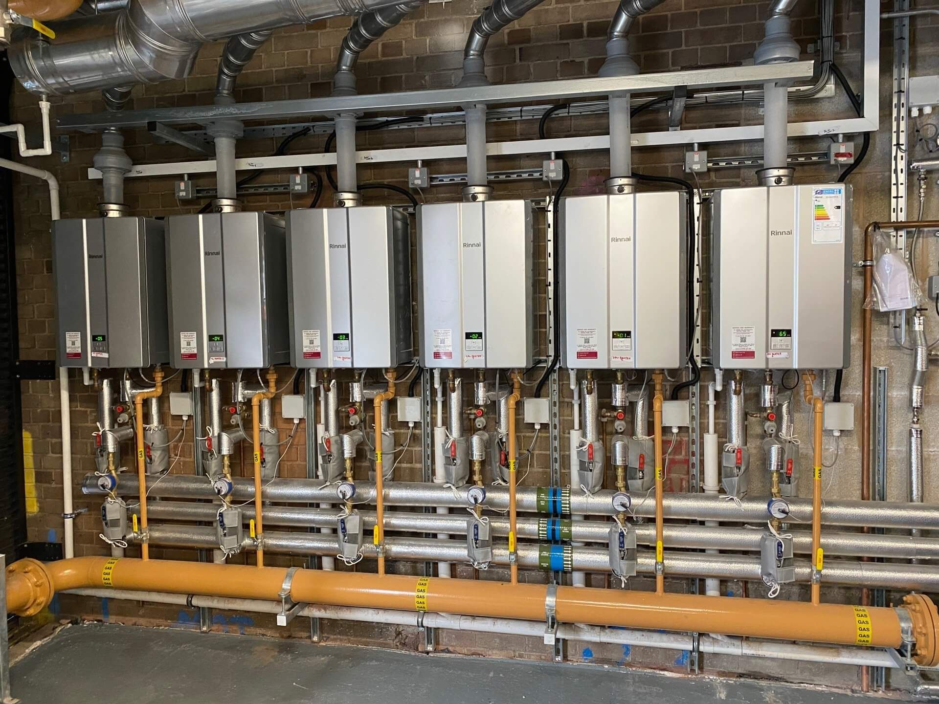 A room filled with lots of pipes and boilers.