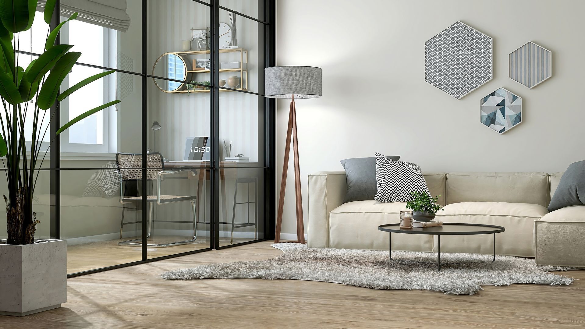 A modern living room with a beige sofa, a shaggy rug, a tripod floor lamp, and a black-framed glass wall to a study area.