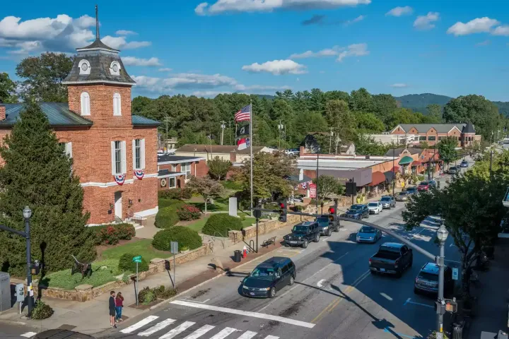 an aerial view of a small town with a brick building in the middle of the street .