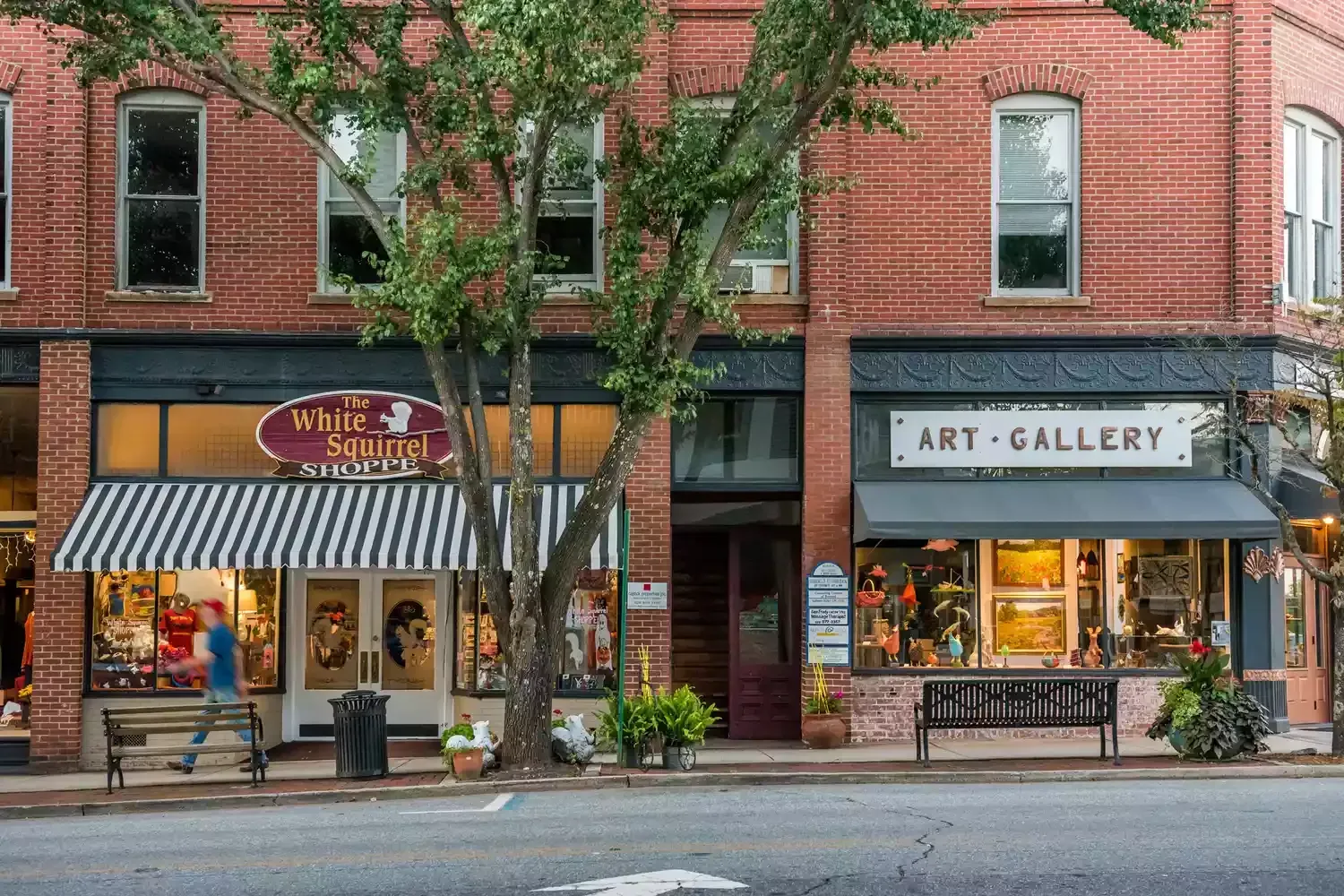 A brick building with a art gallery on the side of it.