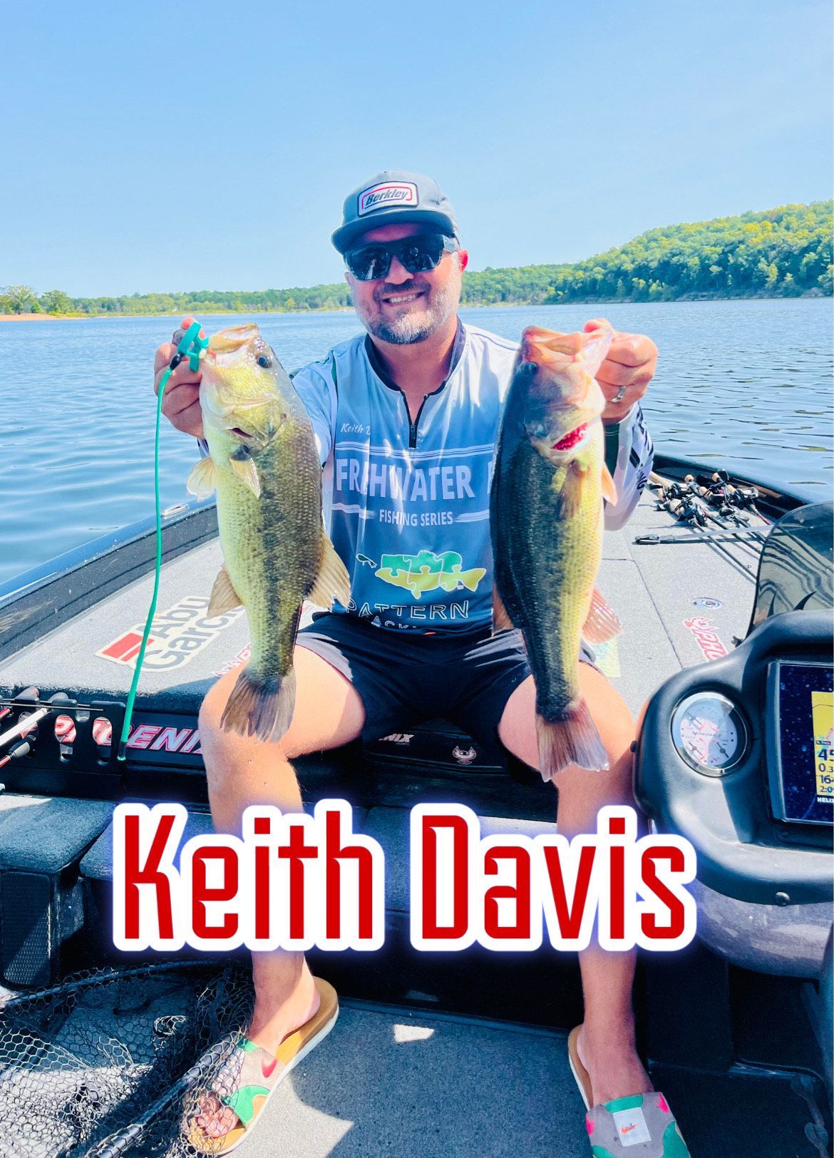 Man on a boat holding two largemouth bass, with “Keith Davis” text overlay.
